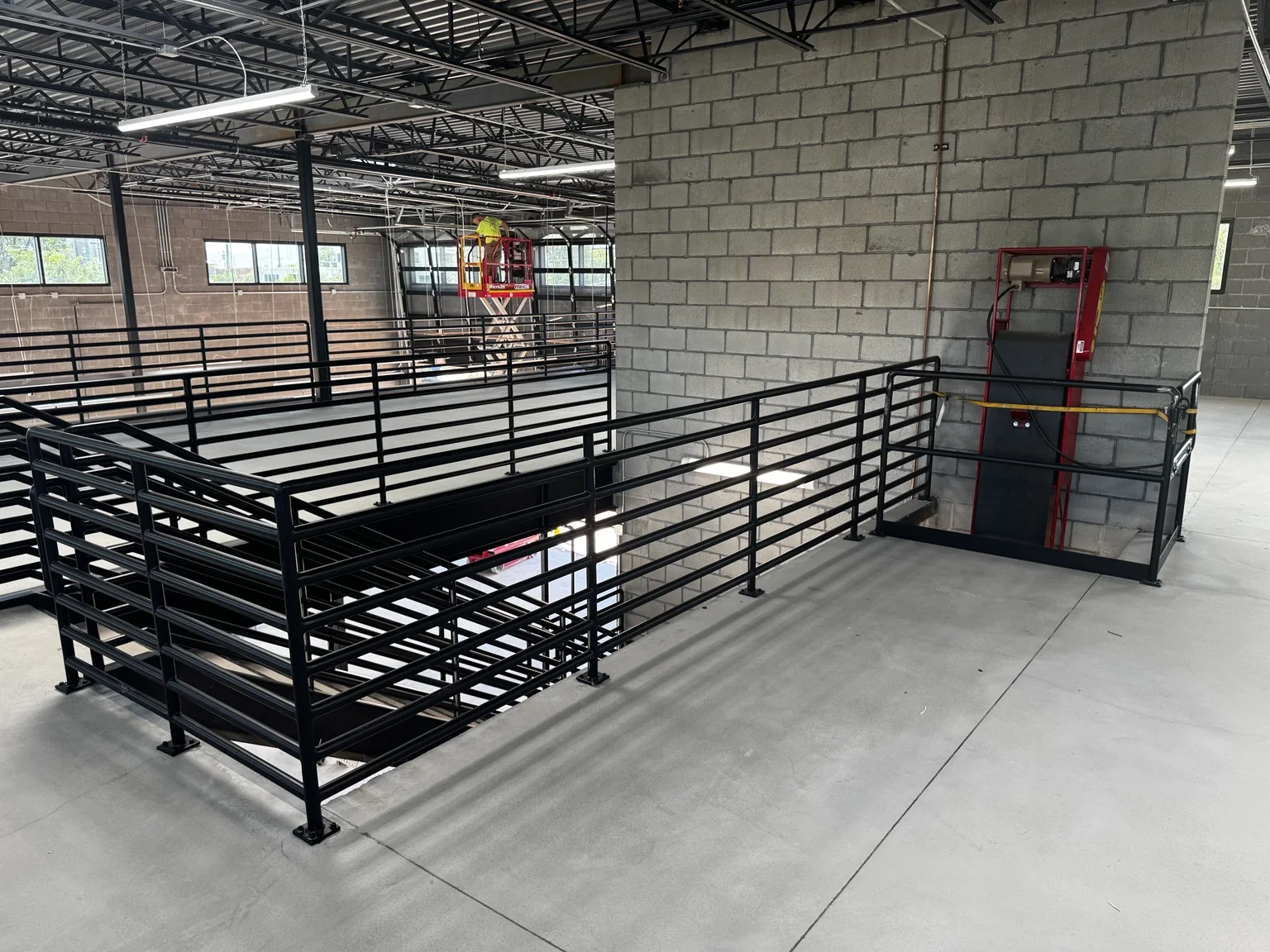 Wide view of painted black metal railings throughout the Big O Tire upper-level commercial workspace