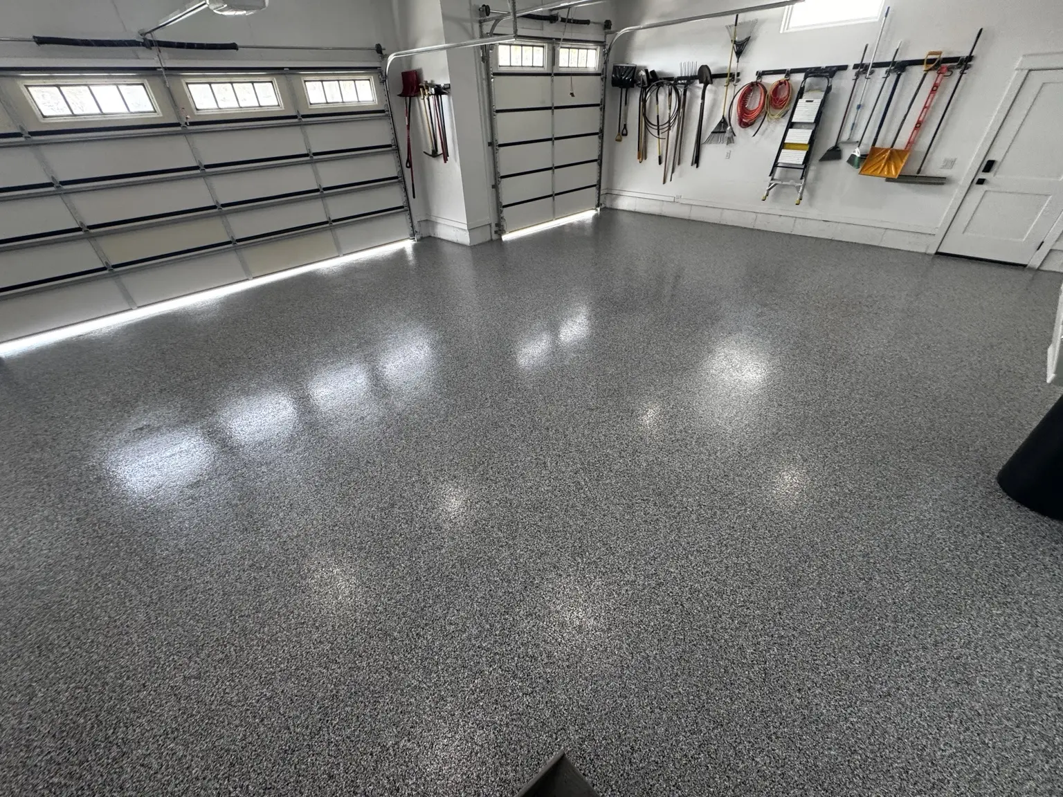 Completed Ogden three-bay garage with a decorative gray flake floor coating